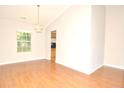 Living room with hardwood floors, a chandelier, and a view through to the Kitchen at 2172 Cold Springs Cir, Lithonia, GA 30058