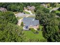 An aerial view of a brick house surrounded by lush greenery at 4759 Highland Point Dr, Auburn, GA 30011