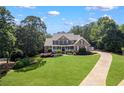Beautiful brick home with a large front lawn and long driveway at 4759 Highland Point Dr, Auburn, GA 30011