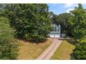 Aerial view of a well-maintained home nestled amongst mature trees on a spacious lot at 533 Coolsprings Walk, Woodstock, GA 30188
