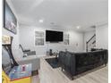 Inviting living room with stylish furniture, a modern TV, and a retro arcade game at 115 Winding River Dr # B, Atlanta, GA 30350