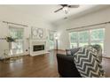 Cozy living room with fireplace, hardwood floors, and large windows at 3275 Cherry Oak Ln, Cumming, GA 30041