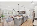 Open-concept kitchen and living room featuring a spacious island, modern appliances, and lots of natural light at 3374 Verdi Ln, Kennesaw, GA 30144