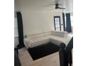 Contemporary living room with a white sectional sofa, a black rug, modern ceiling fan, and lots of natural light at 162 Camden Woods Dr, Dallas, GA 30157