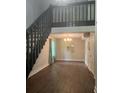 Open-concept living room with hardwood floors, dark staircase, and a view of the second-story railing at 2500 Trent Dr, Marietta, GA 30066