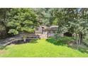 Landscaped front yard and driveway leading to this classic-style home nestled among mature trees at 5510 Stoneybrook Se Ct, Mableton, GA 30126