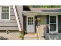 Close up of the front door and brick exterior of this charming home with windowed door and hanging plant at 5510 Stoneybrook Se Ct, Mableton, GA 30126