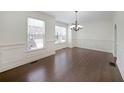 Open dining room with hardwood floors, large windows, and classic molding at 3692 Lambert Ne Ln, Brookhaven, GA 30319