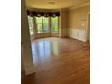 Spacious living room features hardwood floors, trim and large windows, offering great natural light at 4504 Allen Hollow, Suwanee, GA 30024