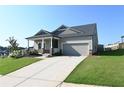 Inviting home featuring a tidy front yard, neutral siding, and an attached two-car garage at 1057 Towne Mill Xing, Canton, GA 30114