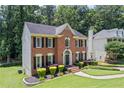 Two-story brick home with neatly manicured lawn and mature trees at 2500 Ashbourne Dr, Lawrenceville, GA 30043