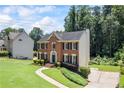 Well-maintained brick home with lush green lawn and established landscaping at 2500 Ashbourne Dr, Lawrenceville, GA 30043