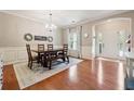 Elegant dining area showcasing hardwood floors, a rustic wood table set, and traditional style decor elements at 6202 Oakdale Ridge Se Ct, Mableton, GA 30126