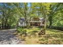 Beautiful home exterior with lush landscaping and a stone accent, offering a serene and inviting curb appeal at 2121 Jep Wheeler Rd, Woodstock, GA 30188