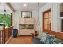 Cozy porch featuring a swing, wooden furniture, and rustic decor, perfect for relaxing outdoors at 2121 Jep Wheeler Rd, Woodstock, GA 30188