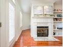 Living room showcasing a fireplace, built-in shelves, and natural light from the french doors at 225 E Ponce De Leon Ave # 310, Decatur, GA 30030