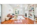 Bright living room featuring hardwood floors, fireplace, built-in shelves, and balcony access at 225 E Ponce De Leon Ave # 310, Decatur, GA 30030