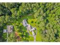 Stunning aerial view of a home surrounded by lush trees and greenery at 4847 Lakewood Dr, Acworth, GA 30101