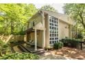 Exterior side view of a home with a deck, stone pathway, and expansive windows at 1192 Cleburne Ne Ave, Atlanta, GA 30307
