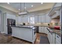 Gourmet kitchen featuring an island, stainless steel appliances, and custom cabinetry at 2160 Kensington Gates Nw Dr, Kennesaw, GA 30152