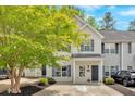 Attractive two-story townhome with lush tree and driveway at 261 Venture Path, Hiram, GA 30141