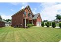 Well-maintained brick home with a spacious lawn, offering a serene outdoor experience at 1147 Scenic Park Trl, Lawrenceville, GA 30046