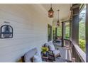 Covered porch with comfortable seating, string lights, and a ceiling fan for outdoor relaxation at 260 W Peachtree St, Norcross, GA 30071