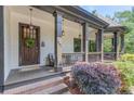 Inviting front porch with seating, decorative plants, and charming details like hanging lanterns at 260 W Peachtree St, Norcross, GA 30071