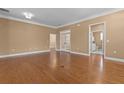 Open living space with hardwood flooring leading to bathroom and doorways at 3209 Telhurst Way, Buford, GA 30519