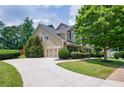Charming home featuring an attached garage and long driveway with a lush lawn at 115 Dunlavin Dr, Acworth, GA 30102
