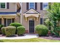 Inviting front entrance with a dark door and manicured shrubbery at 115 Dunlavin Dr, Acworth, GA 30102