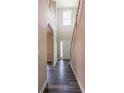 Bright foyer featuring hardwood floors and a staircase with white risers and wood railing at 1849 Wanda Way, Ellenwood, GA 30294
