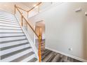 Bright foyer featuring hardwood floors and a staircase with white risers and wood railing at 1849 Wanda Way, Ellenwood, GA 30294