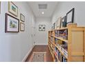 Inviting hallway with hardwood floors, gallery wall, and built-in bookshelves, creating a warm and stylish entryway at 1820 Peachtree Nw St # 1008, Atlanta, GA 30309