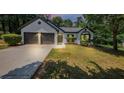 Beautifully landscaped one-story home with a two-car garage and a well-manicured lawn at 3021 Stone Bridge Sw Trl, Conyers, GA 30094