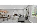 Bright living room with a decorative fireplace, modern furniture, and ample natural light at 6607 Forestdale Ln, Douglasville, GA 30135