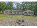 Single-story home with brick accents, wood shutters, and a well-manicured front yard and mature trees at 2546 N Crestview Dr, Grayson, GA 30017