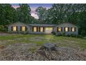 Inviting home exterior featuring a well-lit entry, complemented by a lush lawn and surrounding trees at 2546 N Crestview Dr, Grayson, GA 30017