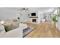 Bright living room with hardwood floors, white trim, and a decorative fireplace open to the kitchen at 2546 N Crestview Dr, Grayson, GA 30017