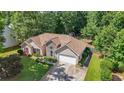 Aerial view of the house showcasing its roof, landscaping, and surrounding trees at 625 Chaseridge Dr, Mcdonough, GA 30253