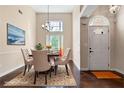 Elegant dining room with high ceilings, modern chandelier, and ample natural light at 625 Chaseridge Dr, Mcdonough, GA 30253