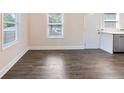 Open dining room with two windows and a door to the kitchen boasting new floors at 1560 Pontiac Se Pl, Atlanta, GA 30315
