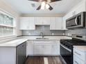 Modern kitchen with stainless steel appliances, white cabinets, and stylish subway tile backsplash at 1560 Pontiac Se Pl, Atlanta, GA 30315