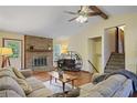 Cozy living room features a stone fireplace, hardwood floors, and a comfortable seating area at 3916 S Martin Way, Lithia Springs, GA 30122