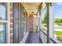 Inviting covered front porch featuring wood decking and decorative railing at 5740 Zelkova Dr, Cumming, GA 30040