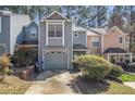 Charming two-story townhome featuring a one-car garage and well-maintained landscaping at 1221 Overton Dr, Lawrenceville, GA 30044