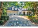 Charming home with mature trees, and well-maintained landscaping enhance curb appeal at 1412 Lanier Ne Mnr, Atlanta, GA 30319