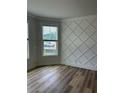 Stylish bedroom with elegant wall trim, hardwood floors, and natural light from windows at 1522 Reserve Glen Dr, Lawrenceville, GA 30043