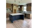 Spacious kitchen featuring an island, shaker cabinets, stone countertops, and stainless sink at 1522 Reserve Glen Dr, Lawrenceville, GA 30043