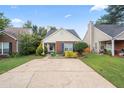 This home features a well-manicured lawn and garden, a brick facade, and a comfortable front porch at 1602 Buckingham Place Pl, Woodstock, GA 30188